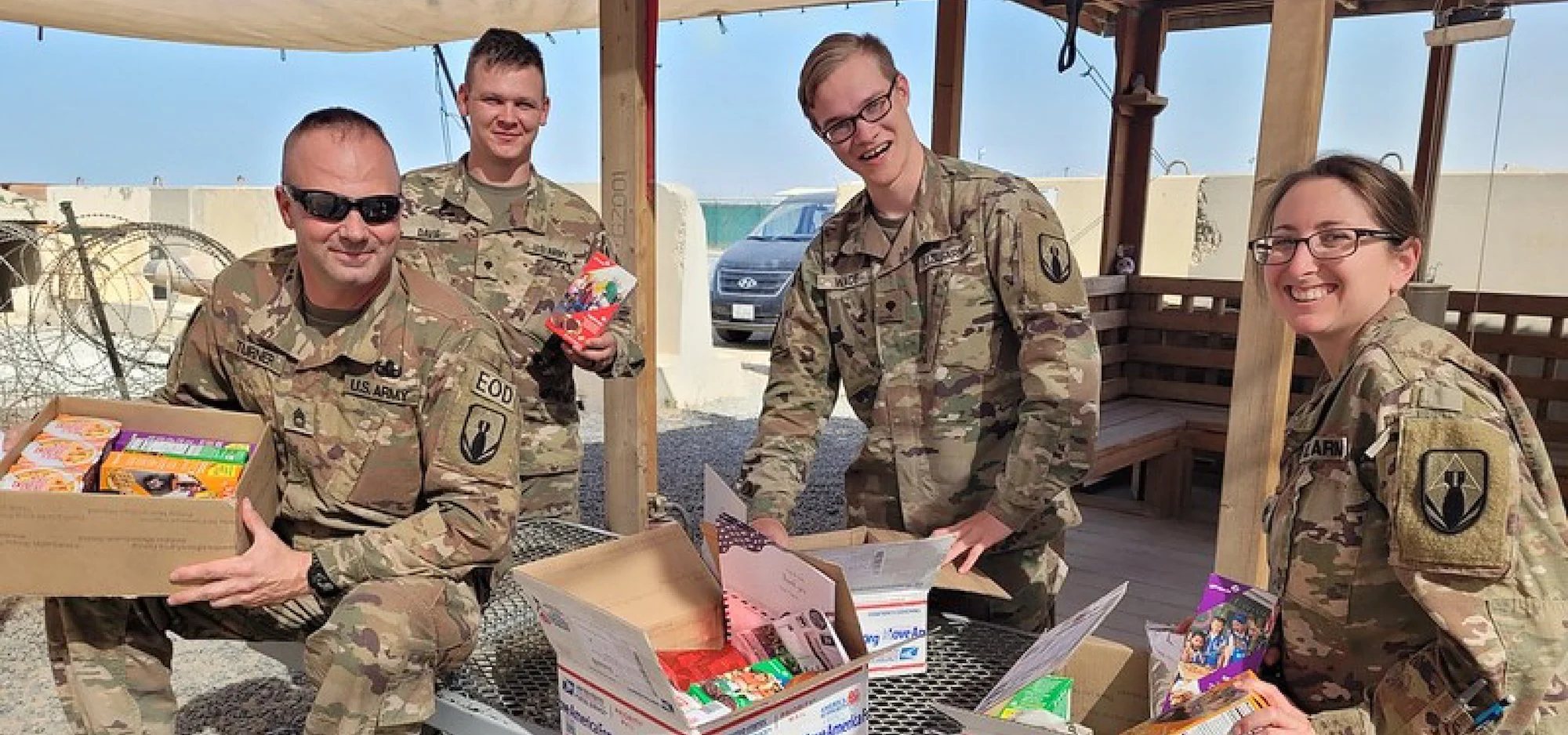 U.S. Army soldiers receiving care packages at a forward operating base