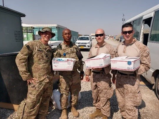 U.S. soldiers holding care packages